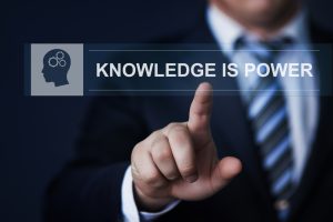 Man pressing screen saying Knowledge is Power