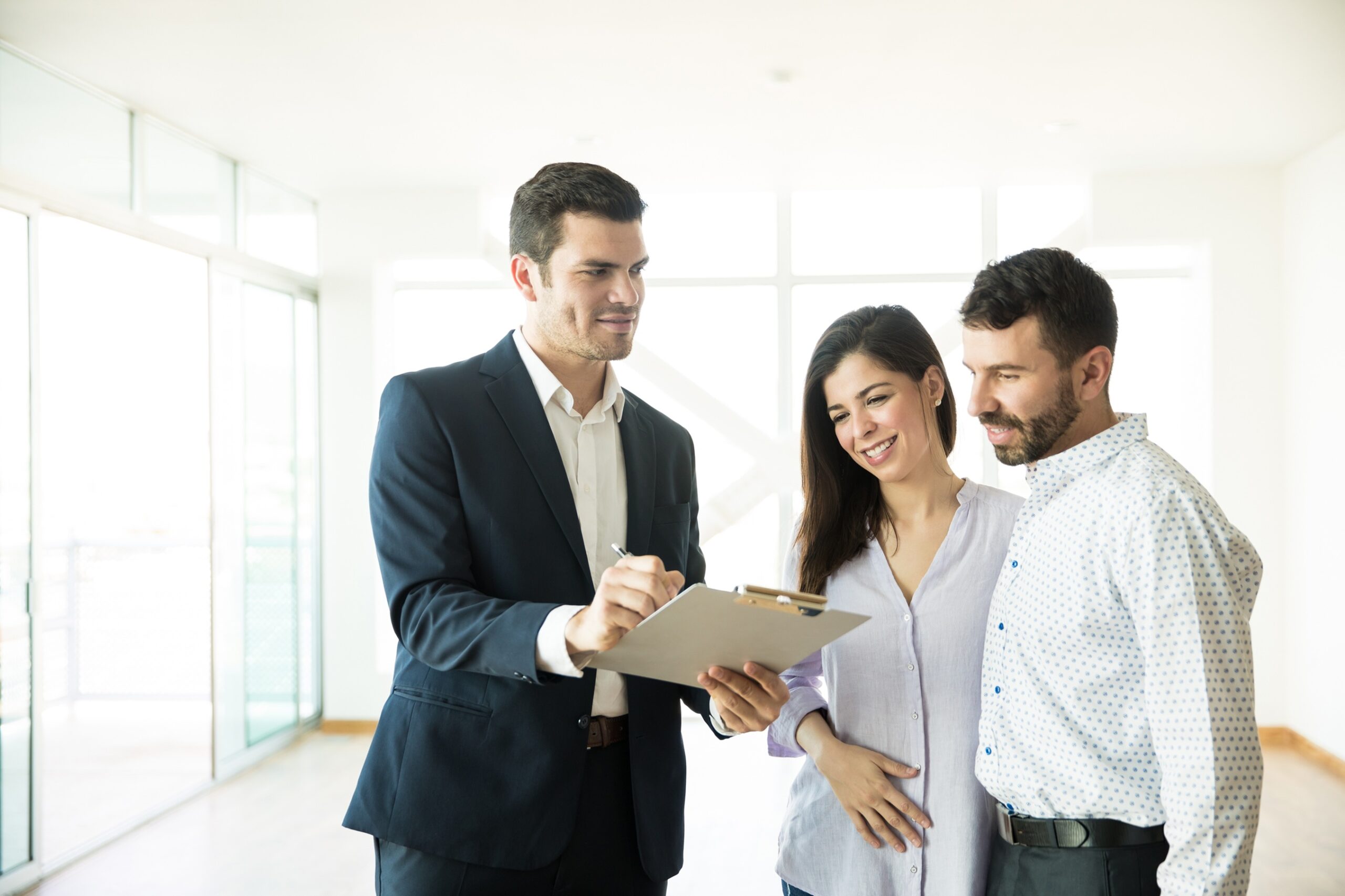 Agent Showing Contract To Couple In New House